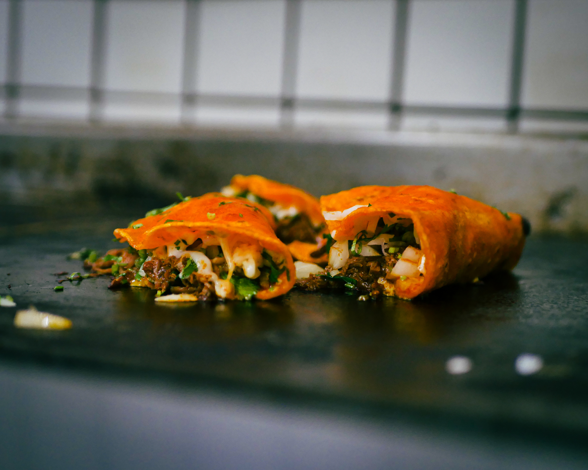 Birria tacos with melted cheese and cilantro — restaurant food photography